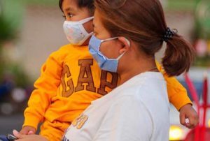 Mother and son in masks during COVID-19