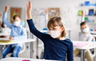 Children wearing face masks are back in school after COVID-19 quarantine and lockdown