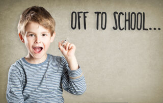 An image of a boy with a pen and the words, Off to School, written on the wall