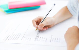 Young, female student taking a multiple choice test in a school, classroom